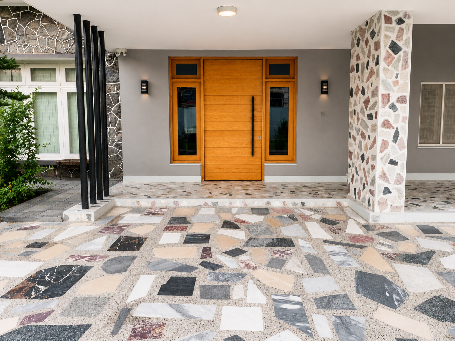 Jhangi House — wooden pivot entrance door and terrazzo porch