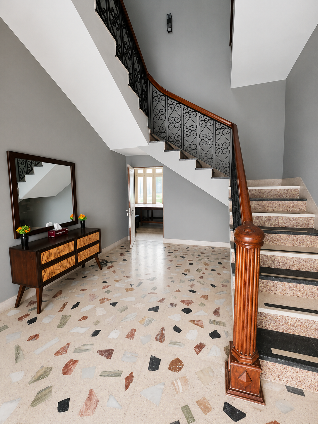 Staircase with ornate wrought iron railings — alternate angle